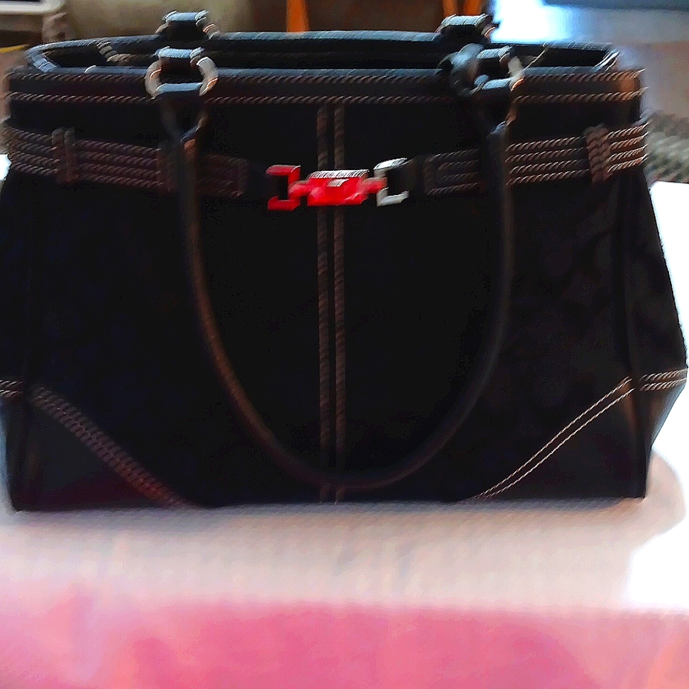 Black cloth purse with leather accents. This is NOT a COACH PURSE.